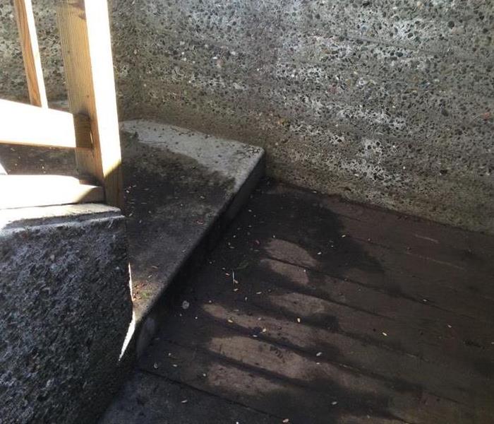 cement wall and wooden stairs damaged by rain storm
