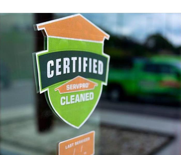 Certified: SERVPRO Cleaned green and orange sticker on top of a window